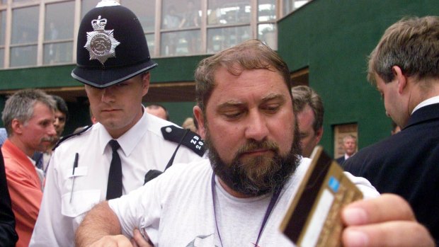 Damir Dokic, father of Jelena Dokic, is escorted by police from the media balcony at Wimbledon in 2000.