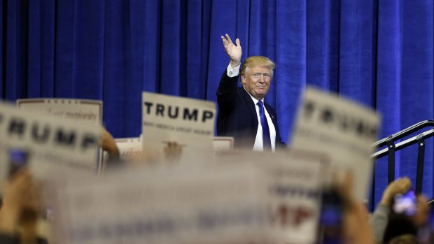 Republican presidential candidate Donald Trump waves as he steps on stage to speak at a rally on Tuesday.