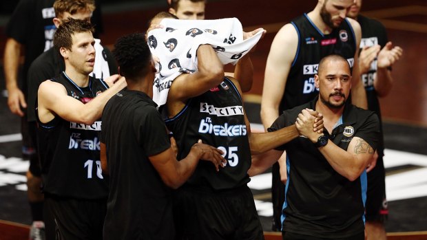 Breakers players applaud Akil Mitchell as he is helped off the court after suffering a serious eye injury on Thursday night.