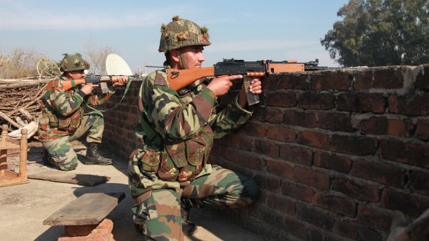 Attacked: Indian army soldiers take positions on a rooftop outside the Pathankot air base.