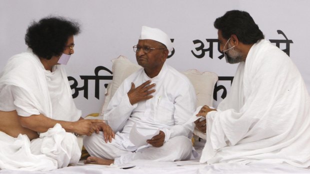 Social activist Anna Hazare, centre, speaks with holy men belonging to the Jain community during a "fast unto death" campaign in New Delhi in 2011.