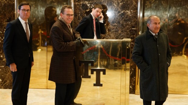 From left, BHP Billiton executive Geoff Healy, chief executive Andrew Mackenzie and chairman Jac Nasser stand in the lobby of Trump Tower in New York.