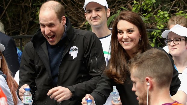 Prince William, Duke of Cambridge is sprayed with water during the London Marathon.