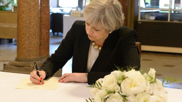 Prime Minister Theresa May signs a condolence book in Manchester. The Tories have taken a dip in the polls since last week's bombing. 