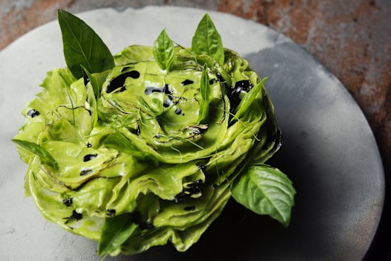 A rosette of iceberg lettuce, coconut, lime and charcoal.