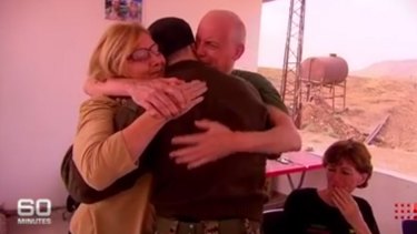 Julia and Scott Dyball reunite with their son, Ashley, in Syria, as Michele Harding looks on.