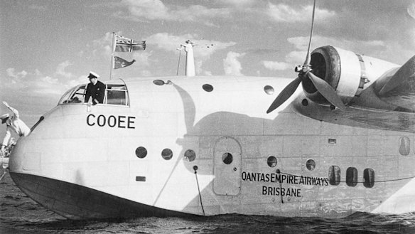 Cooee's captain, Bill Crowther, looks on as radio officer Glen Mumford casts off from a mooring.
