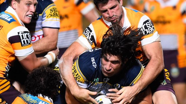 James Tamou of the Cowboys is tackled by Sam Thaiday and Matthew Gillett of the Broncos during a clash between the two teams earlier this year.