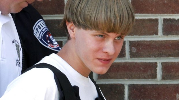 Police lead suspected shooter Dylann Roof into the courthouse.