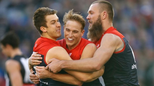 Demons Jack Trengove, Bernie Vince and Max Gawn celebrate the win against Collingwood in round 12. 