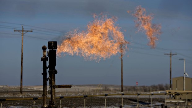A gas flare burns near a crude oil site in North Dakota, US.