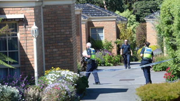 Police outside the block of units in Mitcham, where a man's body was found.