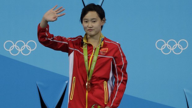 League of her own: China's gold medalist Ren Qian, 15, waves from the podium.
