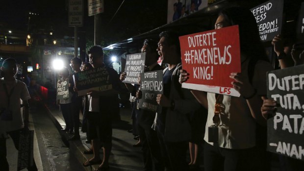 Filipino students shout slogans during a protest on Monday against Duterte's closure of independent news website Rappler.