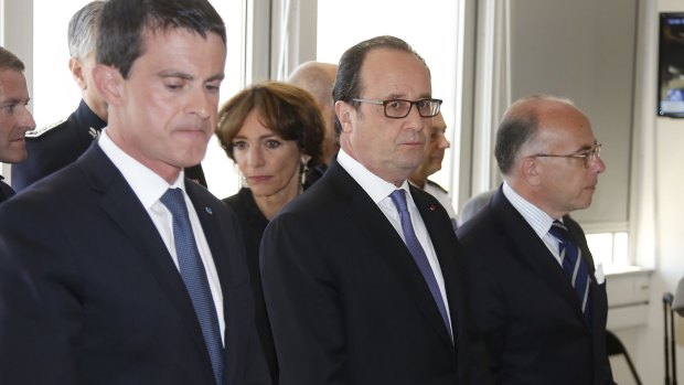 French Prime Minister Manuel Valls, left, French President Francois Hollande and Interior Minister Bernard Cazeneuve attend a meeting the day after the Bastille Day truck attack.