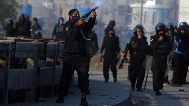 Pakistani police used tear gas to disperse protesters who have blocked a main route into Islamabad for over two weeks.