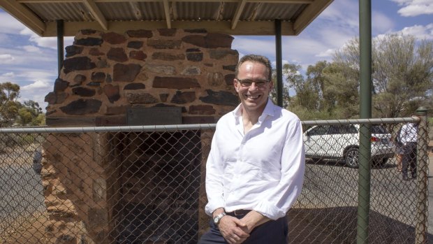 BHP chief executive Andrew Mackenzie in front of the stone chimney that marks the site of the hut built by BHP in May 1885 to house its first manager, William Jamieson.