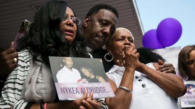 Family members and supporters hug Diann Aldridge, right, during a vigil for her daughter Nykea Aldridge at the Willie Mae Morris Empowerment Center  in Chicago on Sunday.
