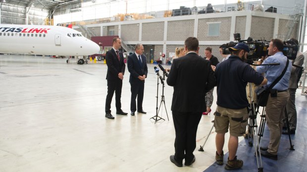 Journalists at a press conference with ACT Chief Minister Andrew Barr and QantasLink boss John Gissing