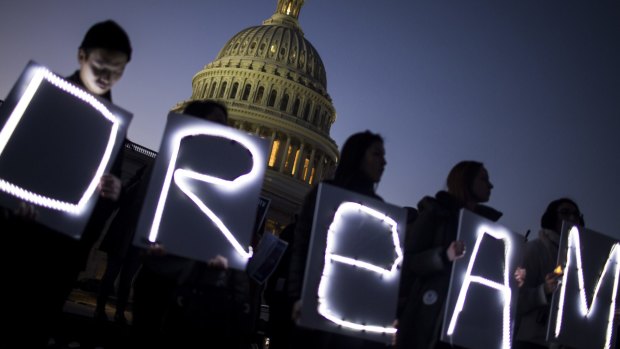 Demonstrators hold illuminated signs during a rally supporting the Deferred Action for Childhood Arrivals program, or the Dream Act, outside the US Capitol building in Washington, DC on Thursday.