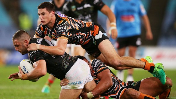 Coach's orders: Mitchell Moses, tackling Robbie Farah at the weekend, was criticised for his last performance in Tigers colours.