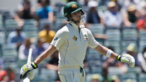 Unhappy: Steve Smith throws his arms out in frustration after he was given out lbw.