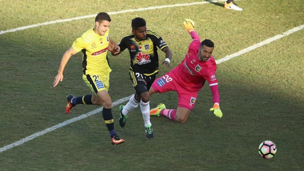 Wizard: Roy Krishna takes the ball past Michael Neill and Paul Izzo on his way to scoring against the Mariners at GIO Stadium in Canberra.