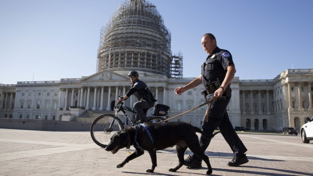 US Capitol Police officers keep watch over the East Front of the Capitol after a fresh threat from Islamic State.