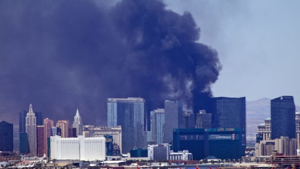 The fire sent plumes of dark smoke over Las Vegas' skyline.