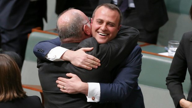 Liberal MP Tim Wilson is embraced by his colleague Warren Entsch after delivering his maiden speech in August.