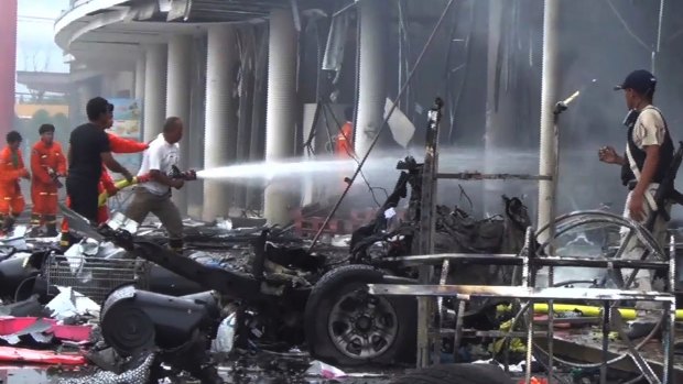 Firefighters try to extinguish the fire after a bomb hidden in a car exploded in southern Thailand in May.