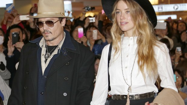 Amber Heard and Johnny Depp, pictured in 2015, will settle their divorce case.