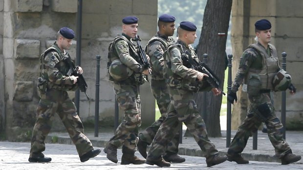 Soldiers keep guard near the England soccer team hotel in Chantilly, France, on Monday.