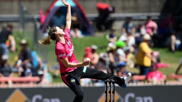 Rhythm: Ellyse Perry charges in to bowl at North Sydney Oval.