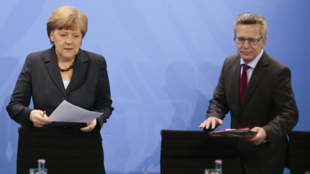 German Chancellor Angela Merkel, left, and Interior Minister Thomas de Maiziere  after a meeting between the German government and the German states about the national asylum policy in Berlin on Friday.