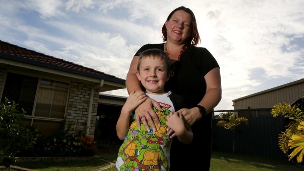 Jesse Burgess with his mother Paula. Paula has bought a border collie to be trained as a therapy dog as an alternative to drugs for ADHD.