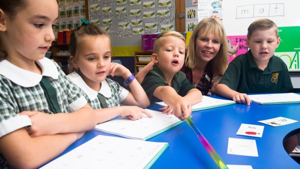 Students Marlia Stewart, Chloe Pratt, Knox Murray and Cameron Trulove, with assistant principal, Katie Harmon, try out a MiniLit session. 