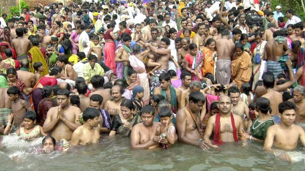 Hindu pilgrims take ritual dips meant to wash away their sins in the River Brahmaputra east of Dhaka in 2004.
