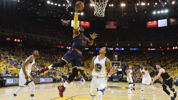 Cavs forward LeBron James lays it in against the Warriors.