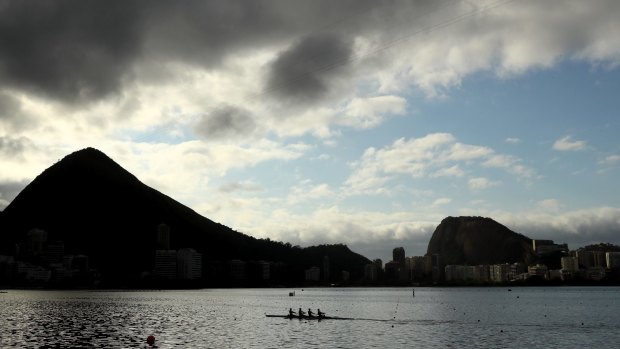 Rowers practice on Lagoa Rodrigo de Freitas, the site of the Olympic rowing venue.