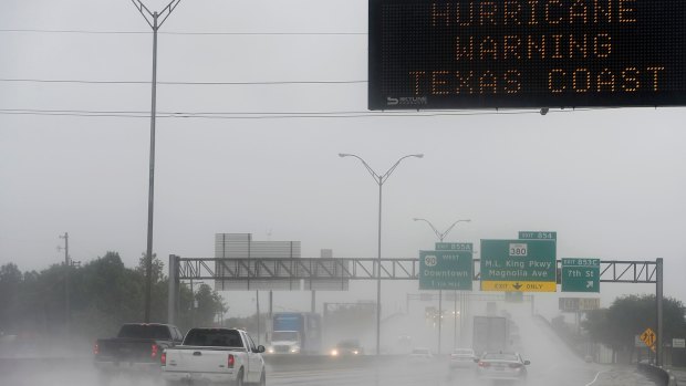 A sign above Interstate 10 in Beaumont, Texas, warns travelers to stay away from the coast as Hurricane Harvey bears down on the state. 