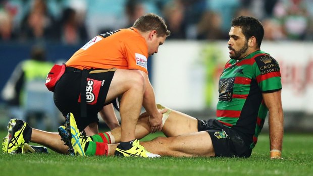 Concern: Souths star  Greg Inglis receives treatment before being forced to leave the field with a knee injury.