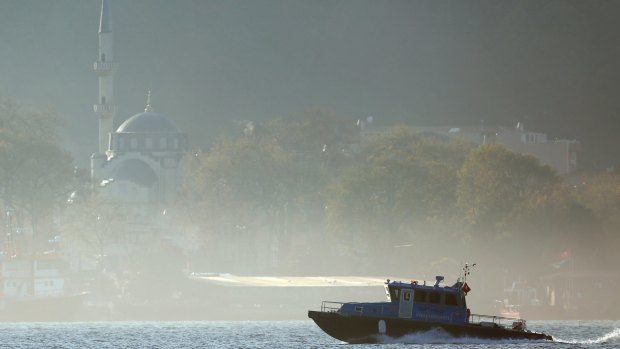 A Turkish police speedboat patrols the fog-covered Bosporus strait, in the outskirts of Istanbul, close to the Black Sea.
