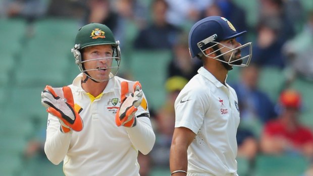 Plenty of talk: Australian wicketkeeper Brad Haddin  exchanges words with Indian batsman Virat Kohli at the MCG.