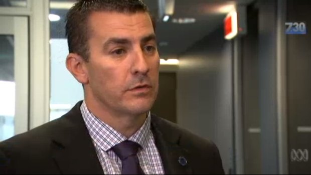 Detective Sergeant John Breda, pictured speaking to the ABC in 2017, was stabbed twice in the torso.