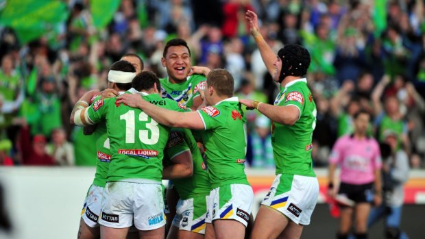 Canberra players including current Raider Josh Papalii, centre, celebrate during their last home final against Cronulla in 2012. 