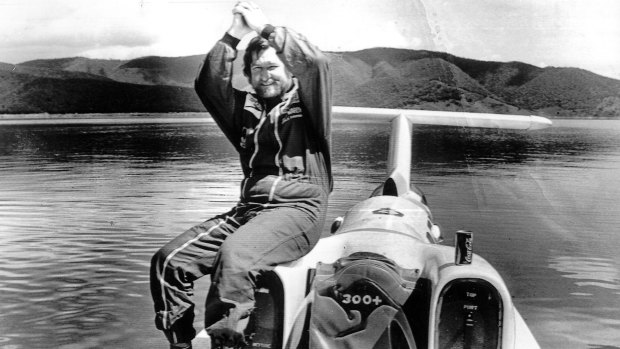 A victorious Ken Warby astride the Spirit of Australia in which he broke the world water speed record.