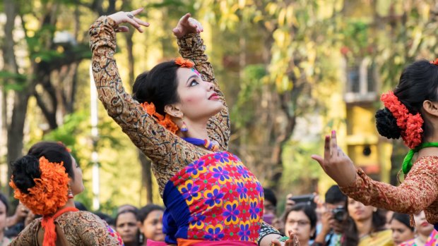 Festival dancers celebrate the arrival of spring in India. 