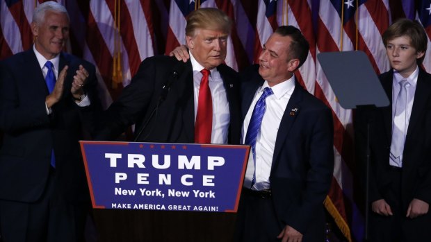 U.S. President-elect Donald Trump, left, embraces Reince Priebus, chairman of the Republican National Committee.