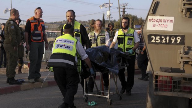 Israeli emergency services evacuate the body of a Palestinian from the scene of an attack near the West Bank Gush Etzion settlements on Sunday.